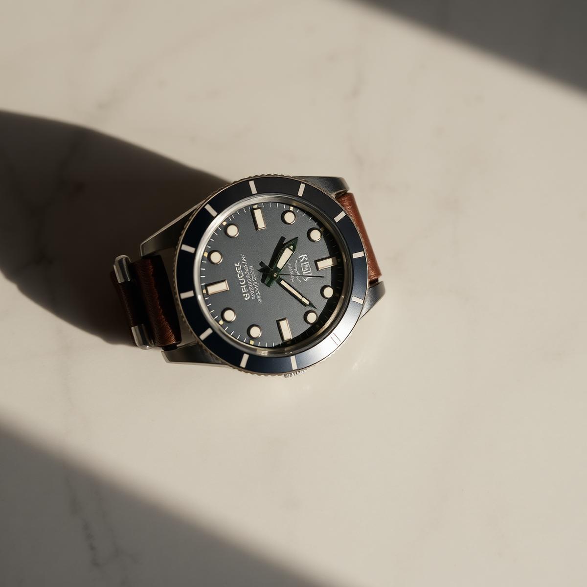 Vintage dive watch on a marble surface